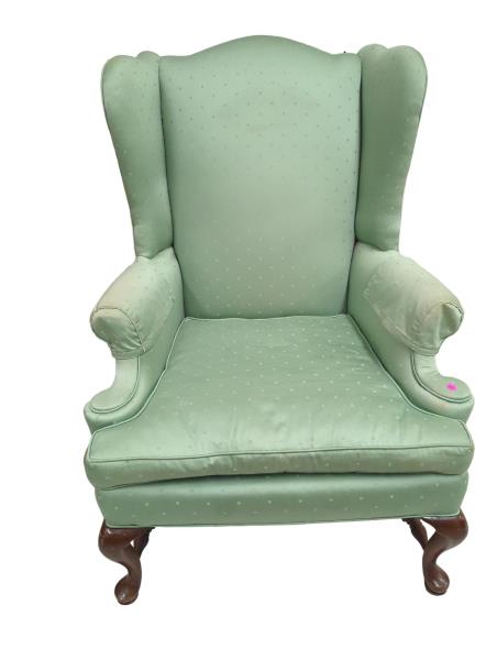 Green Wingback Chair with Wooden Legs and Pink Sticker - Cozy Club Chair with Unique Design